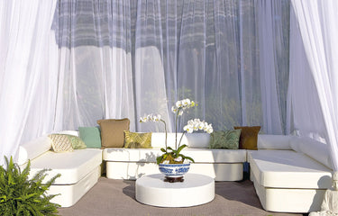 Zen Club Now cabana set in white vinyl: a U-shaped daybed sectional with bolsters and a round floor pad under sheer curtains