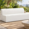 Zig Duo continuous-back bench in white vinyl on a garden terrace, with a stone side table and olive trees behind