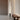 Black Elise floor lamp by Pablo beside a walnut bench