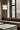 Totem Mini up/down pendant by Pablo over a marble table by a window bench
