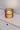 Totem Table Mini amber lamp by Pablo above a credenza