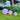 Three Smart & Green Globe spheres glowing violet and pink on a lawn