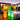 Smart & Green Tango planter lamps glowing orange, green and white on a pool deck