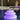 Smart & Green Zen stacked-stone lamp glowing violet on a patio beside a pool