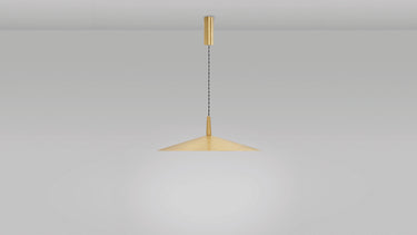 Tinto pendant with a satin brass shade on a braided silk cable, studio view