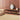 Volute wool rug in Beige, styled in a room