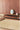 Volute wool rug in Beige, styled in a room