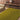 Volute wool rug in Green, styled in a room