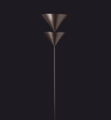 Oluce Pascal floor lamp with two stacked bronze cones on a dark studio background