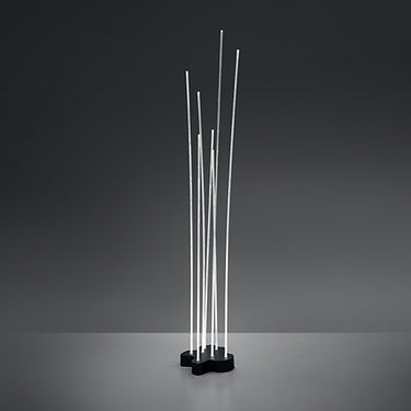 Artemide Reeds Single IP67 outdoor LED floor light with 7 flexible illuminated rods in garden setting