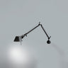Tolomeo Mini black wall light by Artemide with flexible swing arm in modern minimalist interior wall mount