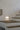 Santa and Cole Cestita lamp on modern bedside table with soft warm glow