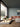Designer Flar Medium Table Lamp by Patrick Norguet casting an ambient glow in a hotel lobby setting.