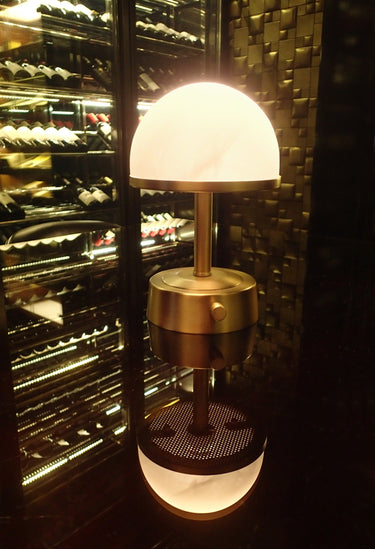 Mini Art Deco Cordless Lamp Antique Brass illuminating a room