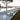 White Big Cube lamp on a stone pool terrace with sun loungers and a tree