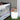 White Cube lamp (14 in) beside a white crib with flowers on top of the cube