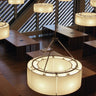 Modern Santa & Cole Sexta circular pendant light hanging above dining table