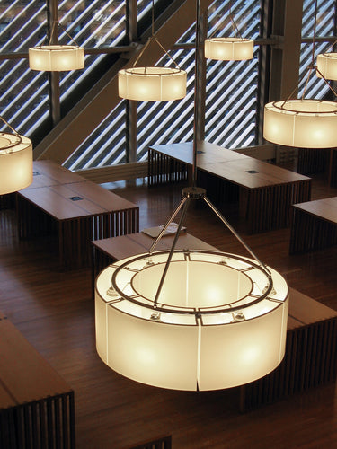 Modern Santa & Cole Sexta circular pendant light hanging above dining table