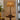 Alexis rechargeable lamp in black with rattan shade on a side table