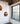 Graypants Bell cardboard pendants hanging by a large window