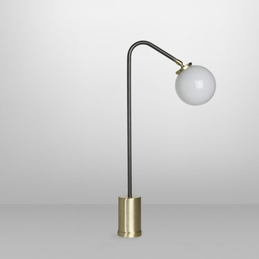 Array table lamp in bronze with a rotating arm and a shiny opal glass globe, studio view
