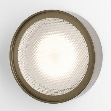 Oluce Berlin-Out round wall lamp in anodic bronze with a textured acrylic disc on a white background