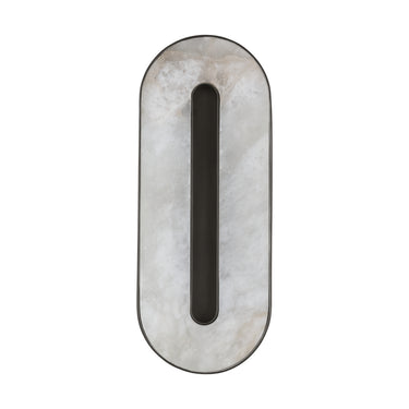 Dimmable Wyllis 12in bronze LED wall sconce casting warm light in a dining area. 