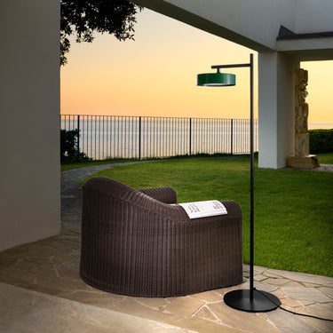 Oluce Berlin-Out floor lamp on a lawn terrace at sunset