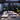 Oluce Berlin-Out floor lamp on a roof terrace lounge