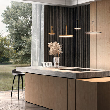 Penta Clip pendants above a kitchen island with garden windows and dark curtains behind