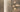 Penta Enoki gold wall sconces with half-dome shades lighting an interior wall