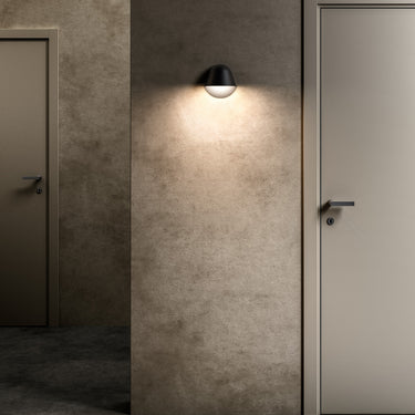 Dark Penta Enoki wall sconce beside a door