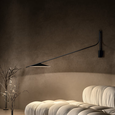 Penta Glifo wall sconce in an interior, black steel shade on a pivoting arm
