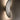 Tall view of a Penta Vela wall sconce glowing on a wall