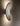 Tall view of a Penta Vela wall sconce glowing on a wall