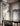 Runa suspension by Penta hanging above a table, with glass arms glowing inside the smoked dome