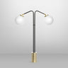 Array twin table lamp in bronze with satin brass details and two opal glass globes, studio view
