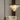 Nimbus chandelier in a gray room beside a cream sofa, seen from further back