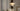 Nimbus chandelier in a gray room beside a cream sofa, seen from further back