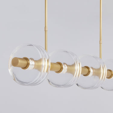 Contemporary LED chandelier for modern interiors featuring 46.7 inch linear brass body and crystal discs