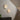 Three Cielo wall lights beside a curved staircase, with two amber and green glass vases on a sideboard