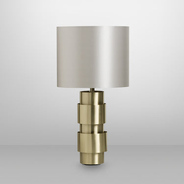 Ring table lamp in satin brass with satin brass details and a dove grey silk shade, studio view