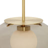 Close-up of the Petra pendant in satin brass with a matt opal inner shade