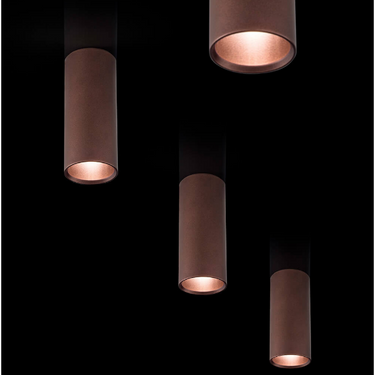 Coppery bronze A-Tube ceiling light fixture by Lodes illuminating a modern living room ceiling