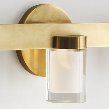 Horizontal mount 5 light bathroom fixture in natural brass finish.