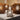 Corten and stainless steel AMS cube lamps on a pale floor
