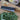 Wide-blade vegetable knife resting on cut greens