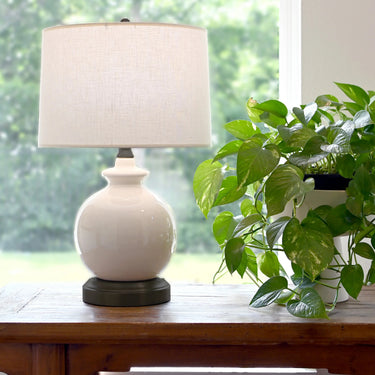 Modern cordless accent lamp with ivory stoneware body and classic proportions