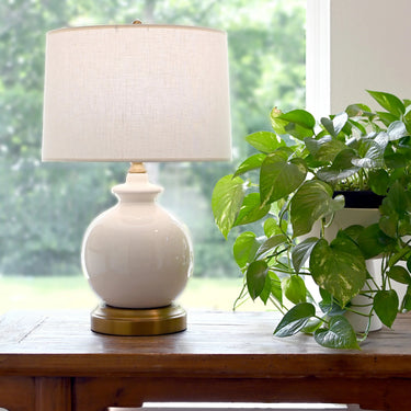 Abbeygale portable table lamp with linen shade and brass base
