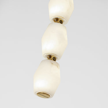 Detail of natural brass and Alabaster glass on Collier 28 wall fixture.